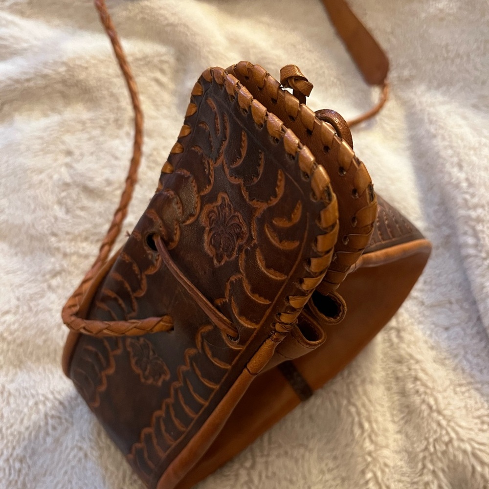 Embossed leather drawstring bag.